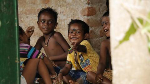 The tribal children having  food with smiling